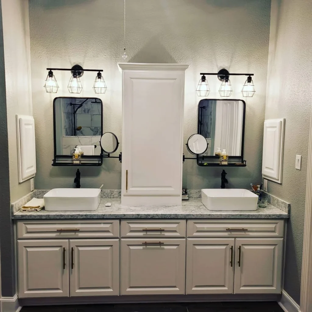 Modern double vanity bathroom with blue cabinets and large mirrors